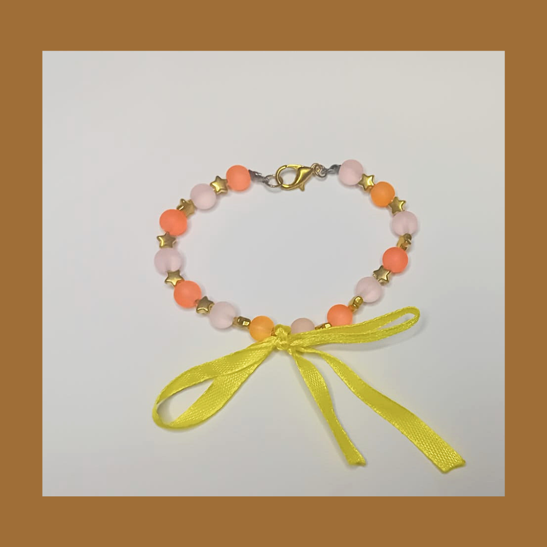 Bracelet with golden stars and yellow lace