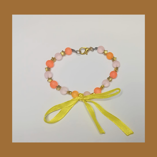 Bracelet with golden stars and yellow lace